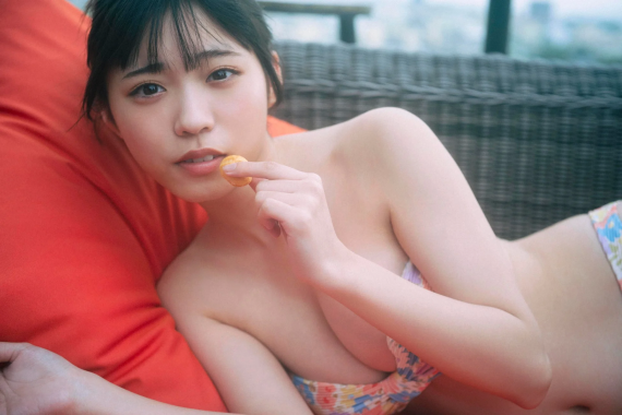 赤いクッションに横たわる水着姿の金澤亜美さん